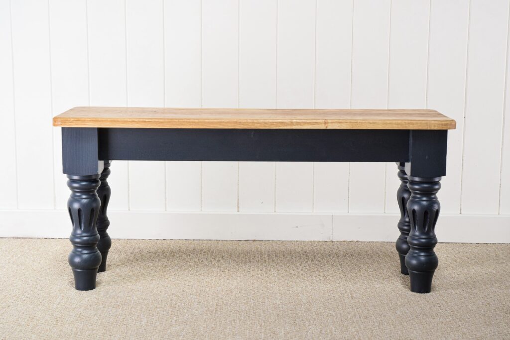 A black table with wooden top and legs.