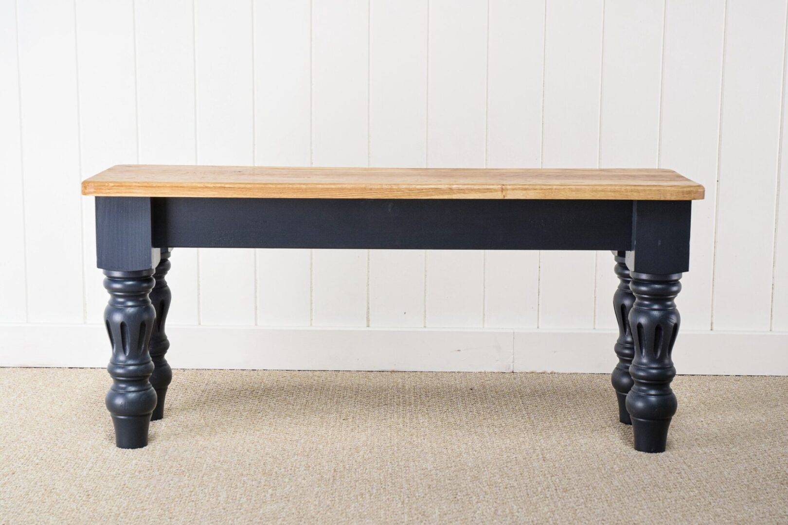 A black table with wooden top and legs.